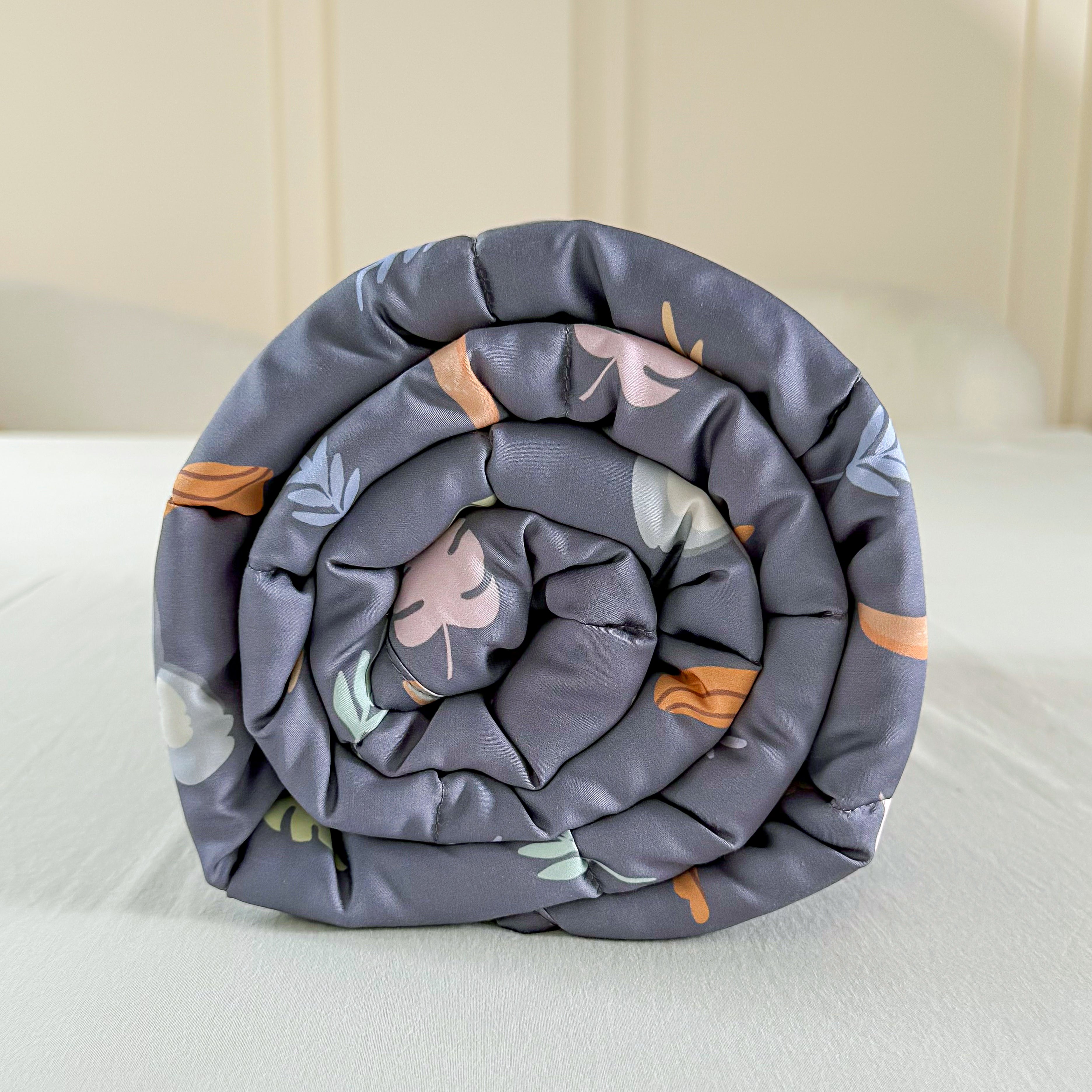 Rolled-up floral-patterned kid blanket comforter on a bed