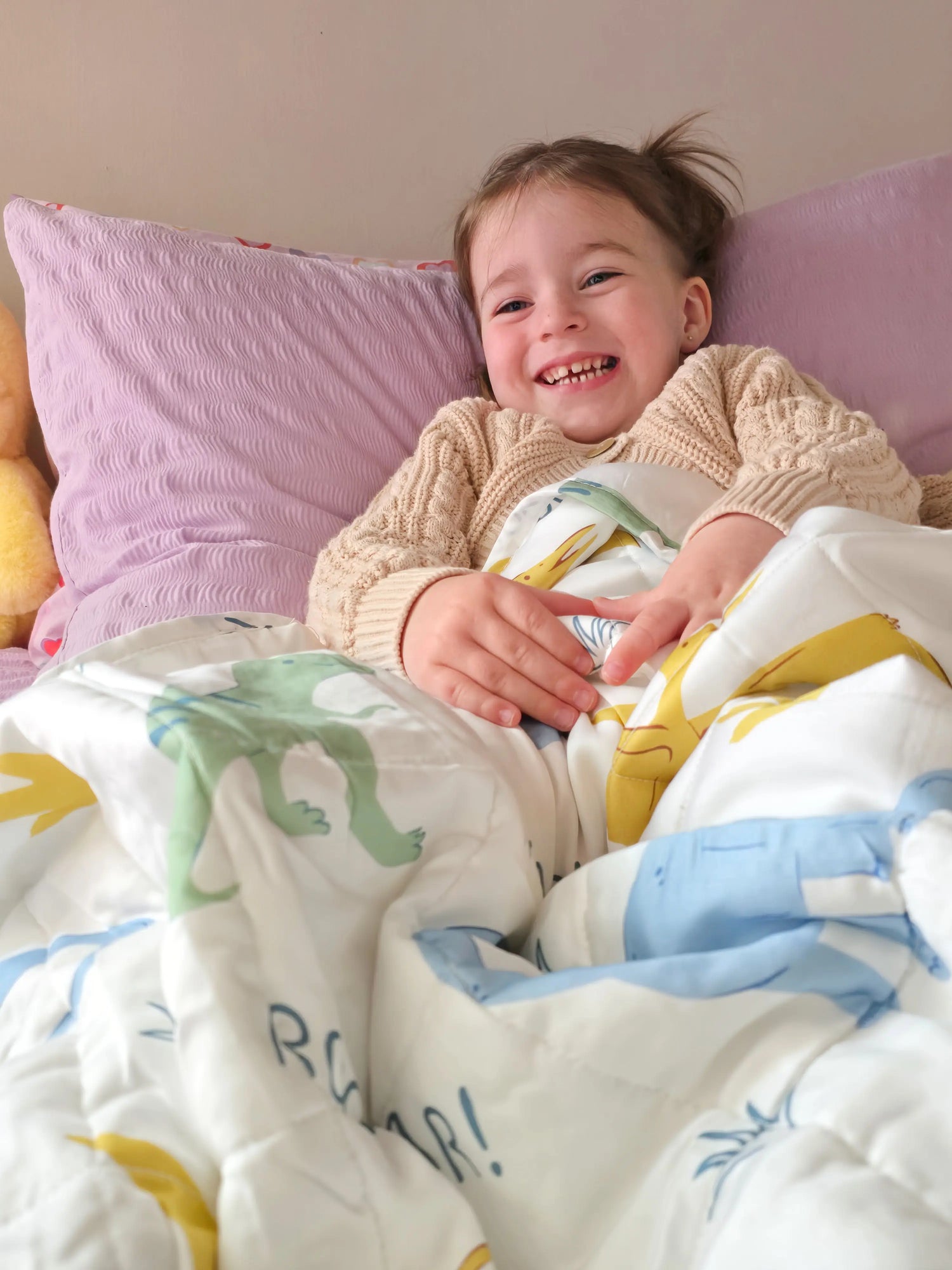 Kids lay on the bed with weighted blanket