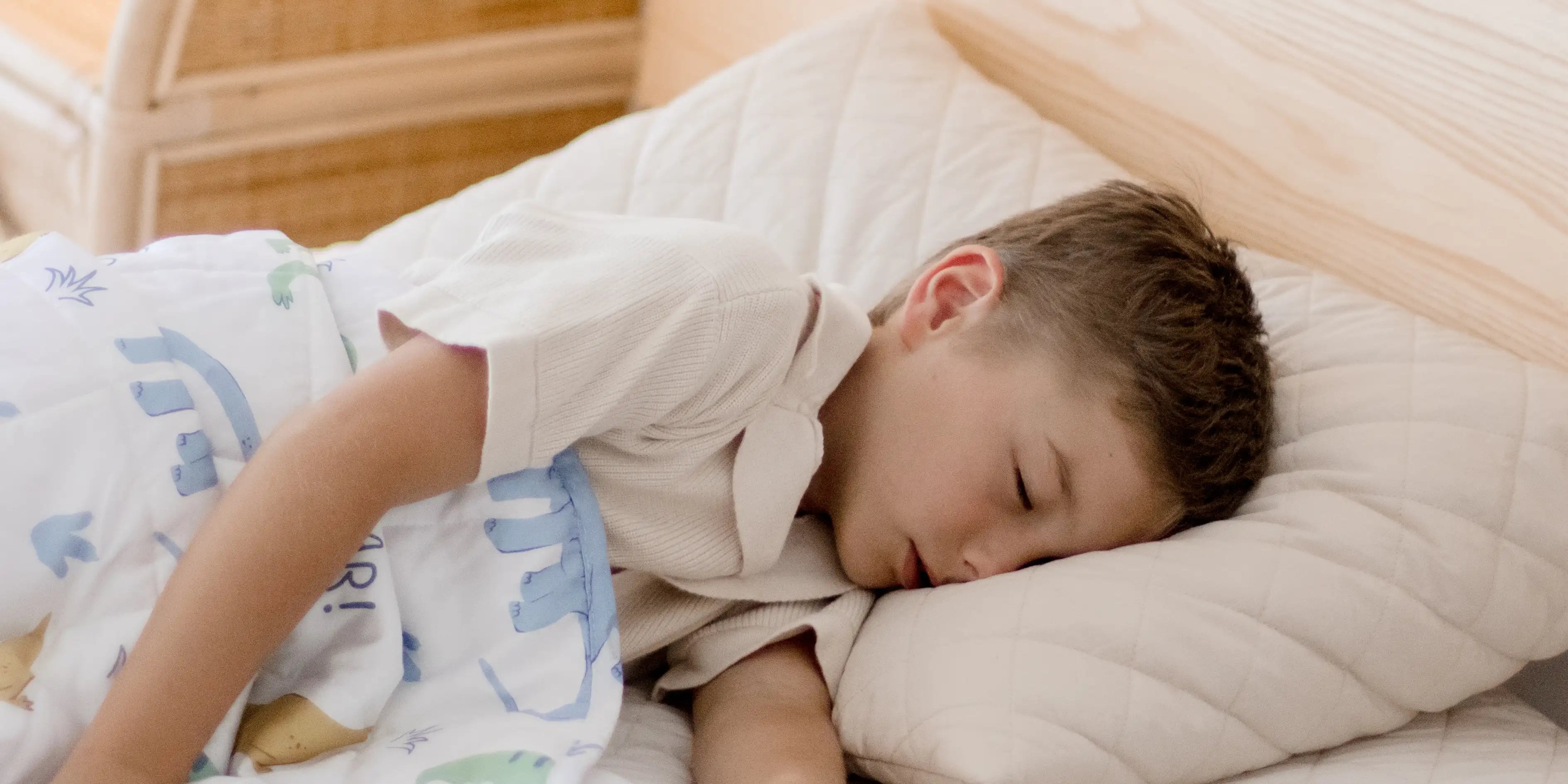Child sleeping with a weighted blanket or bedding.